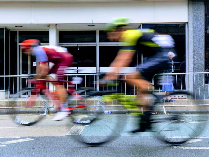 Two cyclists racing, like competitors on dating sites compete for the ladies’ attention.