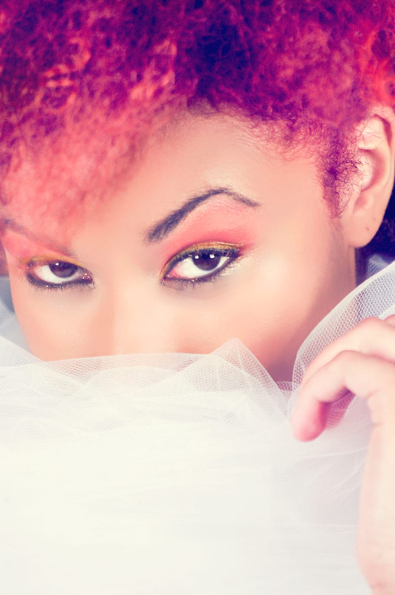 A woman stares intently from behind a scarf. The mystery in her eyes conceals her adultery and adulterous lies.